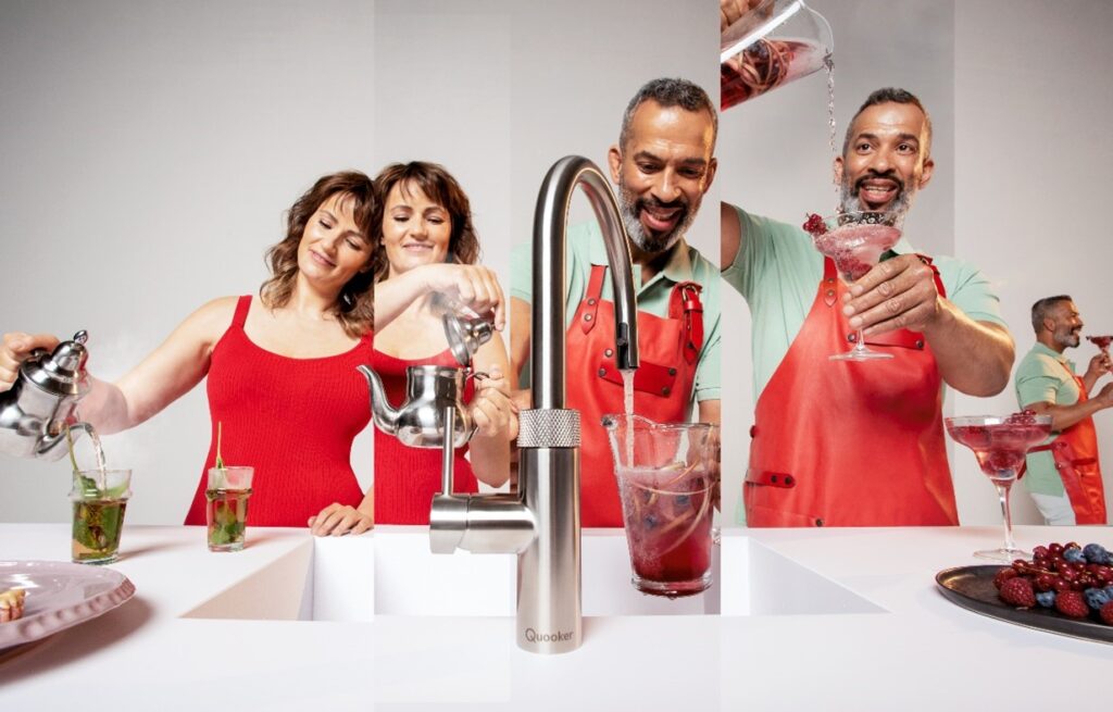 A white kitchen countertop with a couple using the aluminum Quooker Tap
